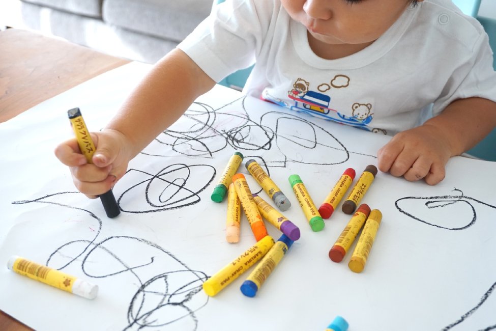 Child drawing with crayons